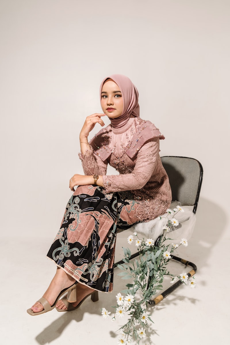 Look 06 — bold burnt sienna garment against dark backdrop